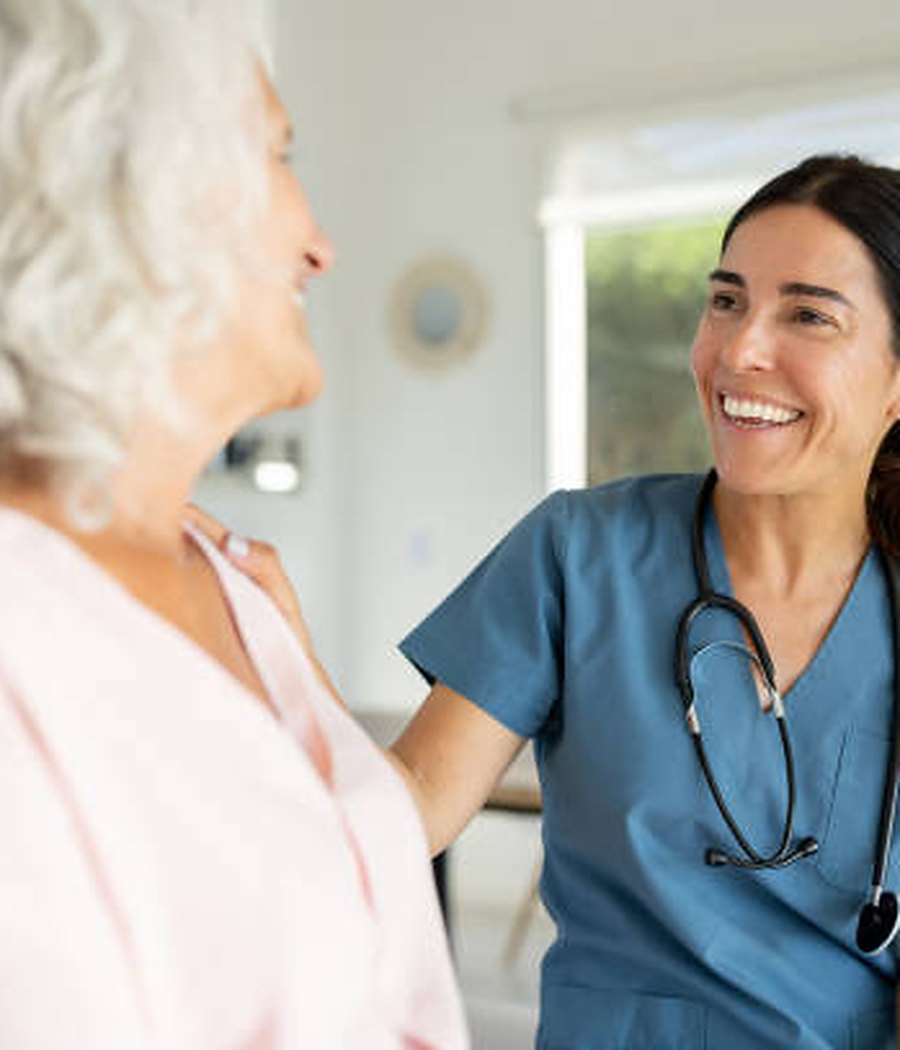 A clinician talking with a patient during a home visit